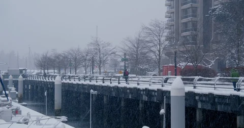 Urban path by ocean during snow storm Video stock 129783857