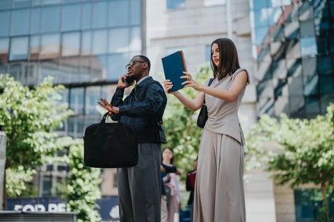 Urban people engaged in work tasks outside a modern office building Stock Photos