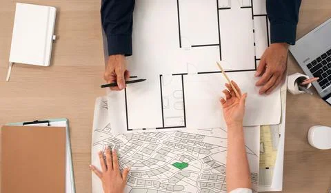 Urban Planner Studies City Map On Laptop, Planning Land Development Project. Stock Photos