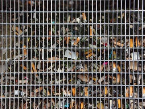 Urban Renovation Trash behind Solid Metal Grid Stock Photos