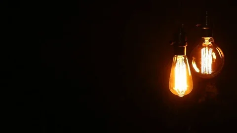 Urban Retro Hanging Light Bulbs on Black Background Stock Footage
