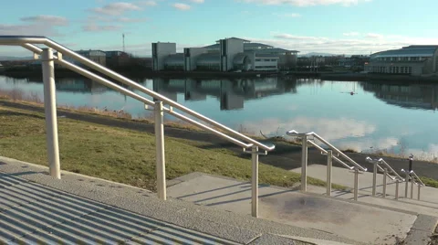Urban river across modern steps, Man walks down. Stock Footage 1064772