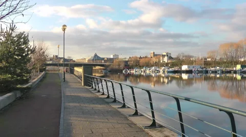 Urban River footpath with boat yard and bridge. Stock Footage 1058623