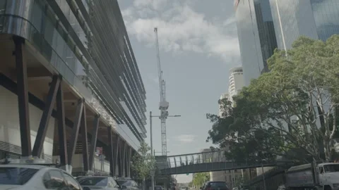 Urban Road Traffic Passing Construction and Pedestrian Bridge in Sydney CBD Stock Footage 341690648