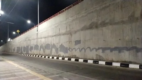 Urban road under flyover at night Stock Footage 338185151