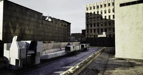 Urban rooftop view featuring industrial structures and city buildings at dusk Ilustración de archivo