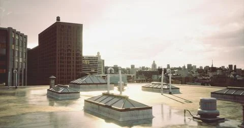 Urban rooftop view at sunset showcasing city skyline and buildings Ilustración de archivo