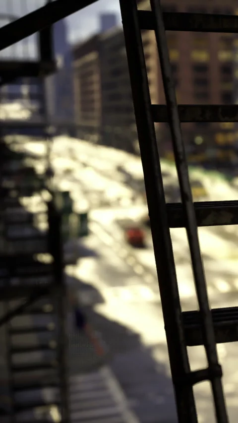 Urban scene captured from a fire escape showing buildings and street below Stock Footage 331688514