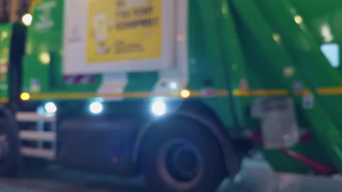 Urban Scene at Night Featuring a Garbage Truck Actively Cleaning the Streets of Stock Footage 318557221