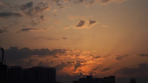 Urban silhouette with a dramatic sunset orange clouds and sun disk Stock Footage 127247201