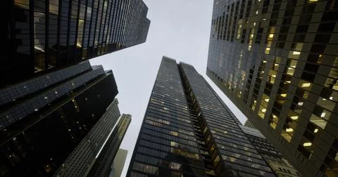 Urban skyline captured from below showcasing modern architecture at dusk Ilustración de archivo