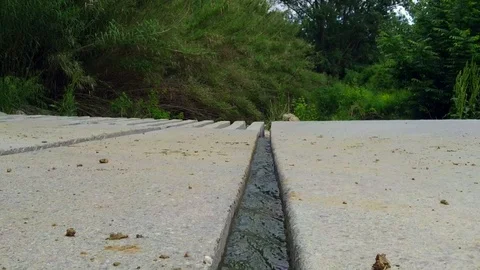 Urban small stream flowing through a countryside little canal construction Stock Footage 118776567