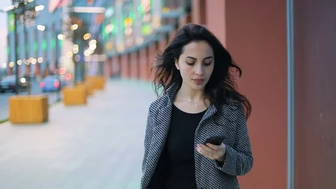 Urban span of young dark brown-haired girl in strict gray jacket and black dress Stock Footage 75441773