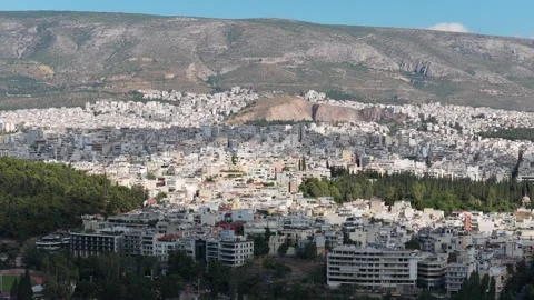 Urban sprawl in Athens, Greece, panoramic cityscape with mountains background, r Stock Footage 337311769