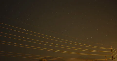 Urban starry galaxy night sky time-lapse over power lines in city. Stock Footage
