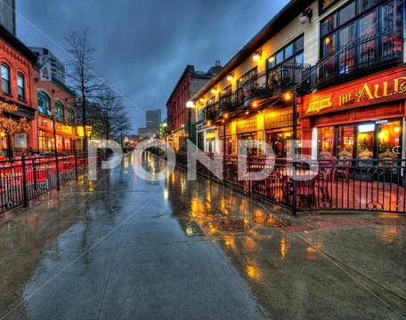 Urban street photo with rain water reflections Stock Photos