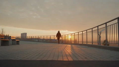 Urban sunrise dance scene evolution. Solitary performer glides gracefully at Stock Footage 338006216
