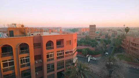 Urban Sunset Over Marrakech With Warm-Toned Buildings And Rooftops Video stock 302905926