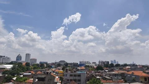 Urban texture with white clouds in the sky Фото