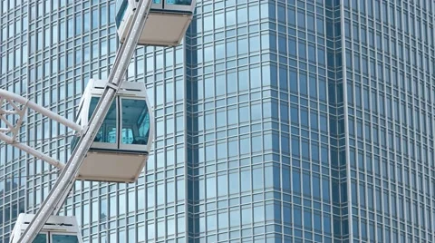 Urban Tower Stands behind Moving Ferris Wheel Vidéo 63346385