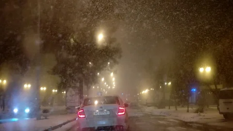 Urban Traffic, Driving in the Night Snowfall, Blizzard, Ice Storm, Non-Flying Stock Footage 71422453