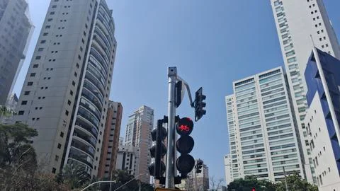 Urban traffic intersection with red light signal. Busy city street scene Stock Photos