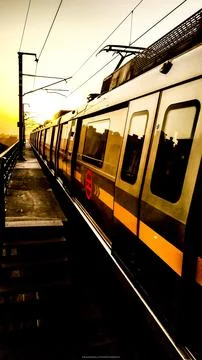 Urban Train on Elevated Track at Sunset Stock Photos