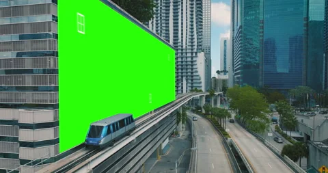 Urban train passing a green screen placeholder wall in a modern city - 3D Stock Footage 194670525