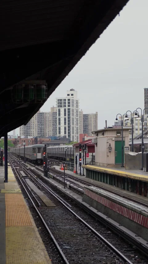 An Urban Train Station featuring a stunning City Skyline in the background, Stock Footage 291023937