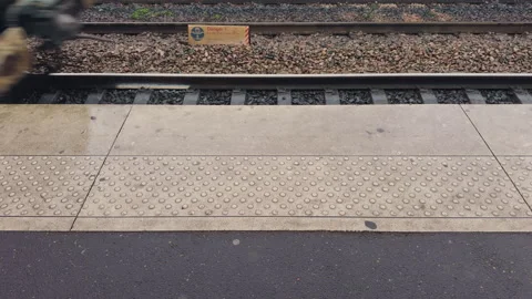 Urban Train Station An UpClose Perspective of the Train Alongside the Platform Stock Footage 318553733