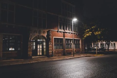 Urban vibes at night with red building and street light Stock Photos