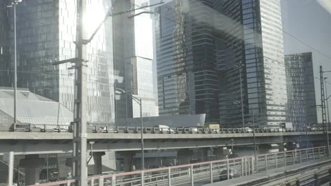 Urban view from train window. Bridge constructions with road with cars Vidéo 154121783