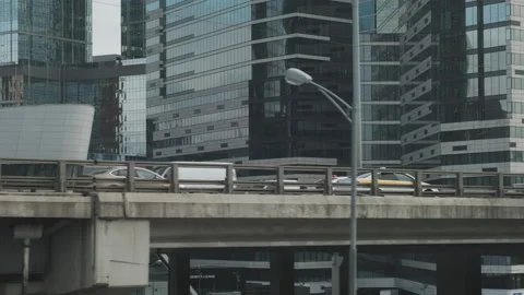Urban view from train window. Bridge constructions with road with cars Видео 154356521