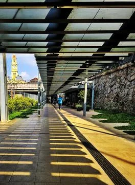 Urban walkway with sunlight patterns Stock Photos