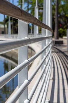 Urban waterfront railing with perspective lines and light shadows. Stock Photos