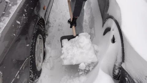 Urban winter chore involving precise snow removal for vehicle access Stock Footage 327894438