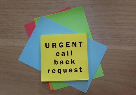 Urgent call back request text on colorful notepad on wooden background Stock Photos