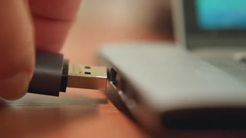 Urgent tech task. Focused student hurriedly plugs in USB amidst scattered notes Stock Footage 342283976