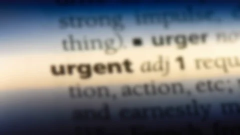 Urgent word in a dictionary. Stock Footage 99562538