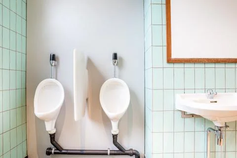 Urinal and sink Stock Photos