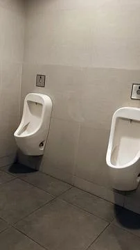 Urinal Bowl With Automatic Flush Stock Photos