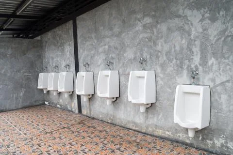 Urinal on cement wall texture Stock Photos