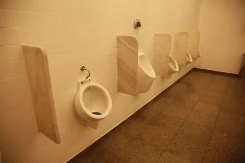 Urinal in a public bathroom Stock Photos