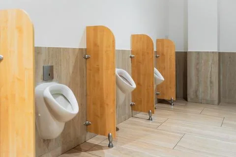 Urinal in a public restroom Stock Photos