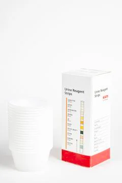 Urine Strips Box And A Stack Of Plastic Containers Stock Photos
