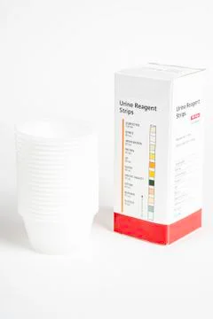 Urine Strips Box And A Stack Of Plastic Containers Stock Photos