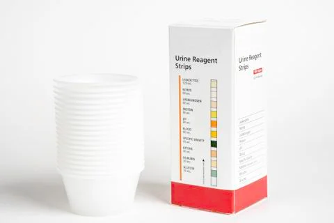 Urine Strips Box And A Stack Of Plastic Containers Stock Photos