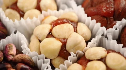 Urkish sweets appear to be assorted stuffed dates, with one variety featuring a Stock Footage 336474222