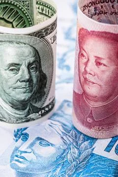 US $ 100 banknote face to face with a hundred Chinese yuan banknote. Concept  Stock Photos