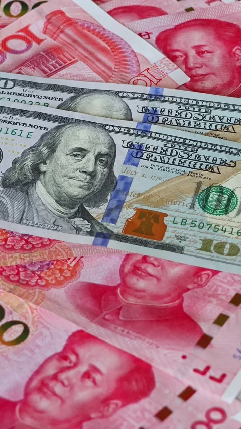 US 100 dollar banknotes falling on Chinese yuan (CNY) bills Stock Footage 332242338